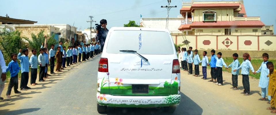 Youth volunteers distributing campaign materials in a rural district
