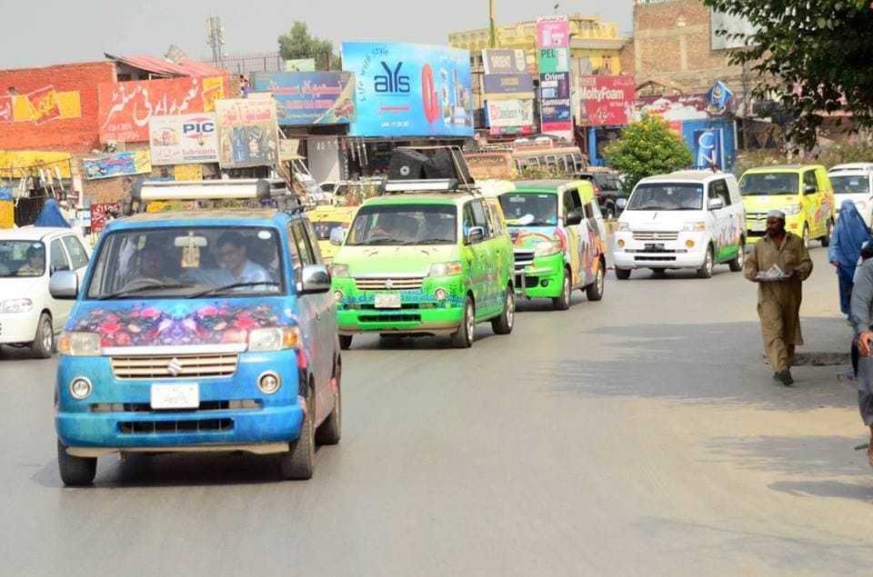 Campaign vehicles driving through towns during the Awaz outreach programme