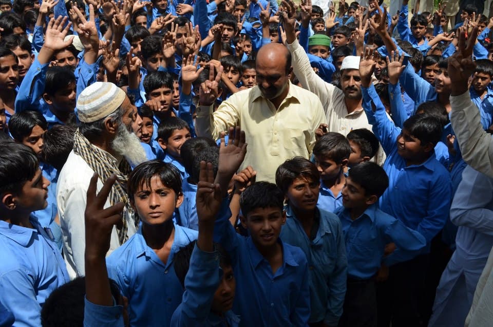 Children and community workers during a school outreach visit