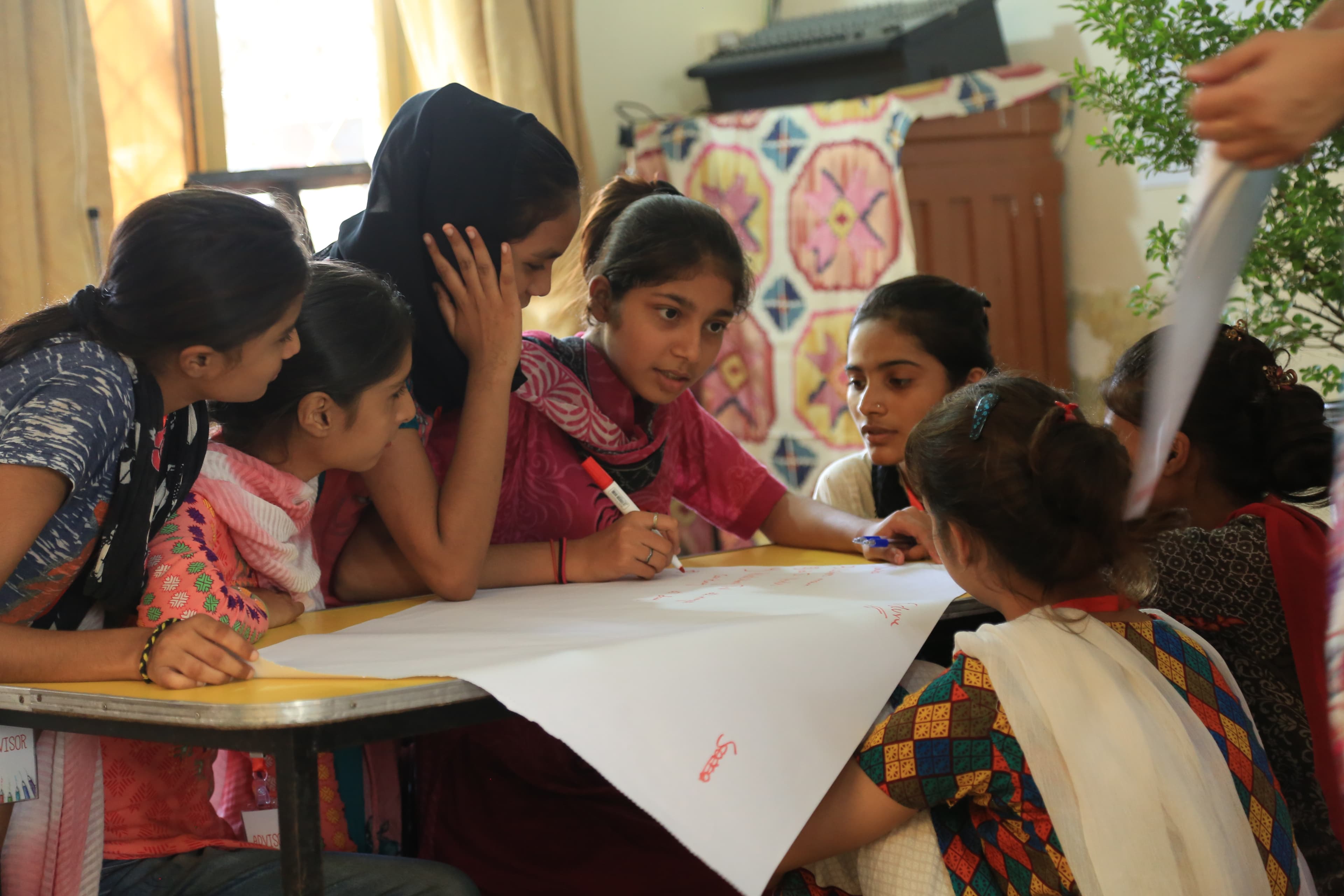 Girls sketching character ideas during a Springster content co-creation workshop