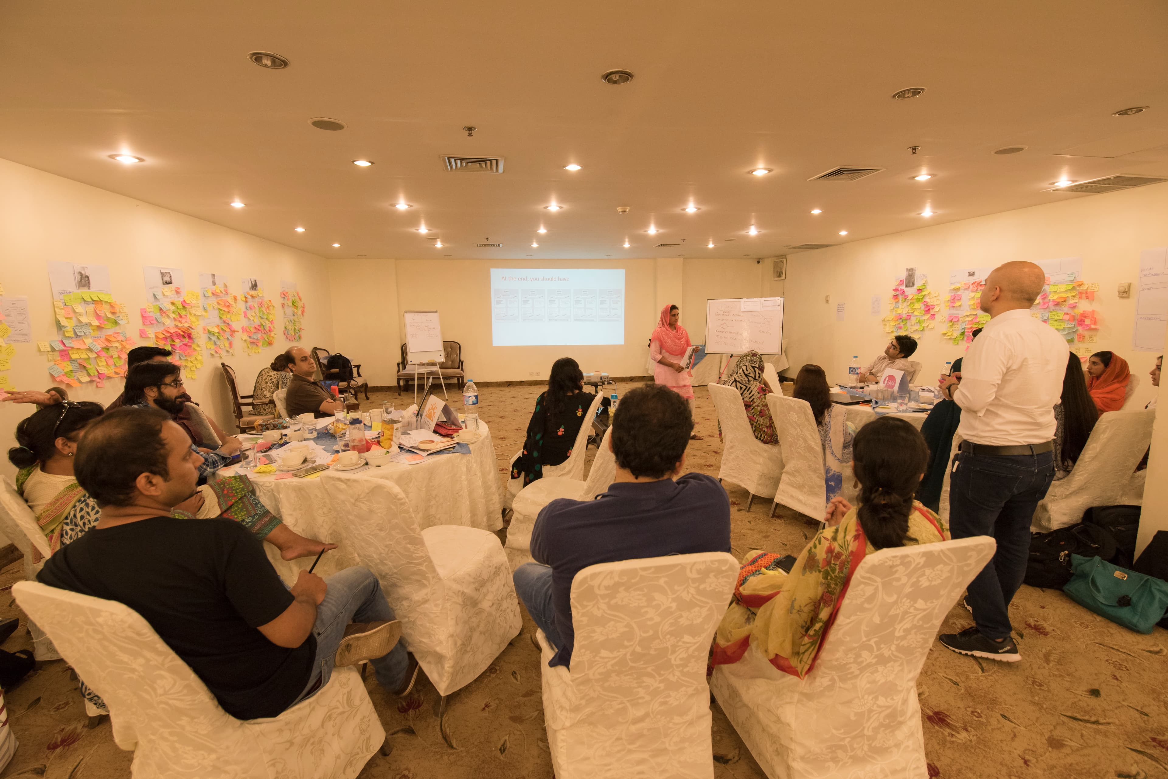 Participants mapping user journeys on a large paper sheet during a design workshop
