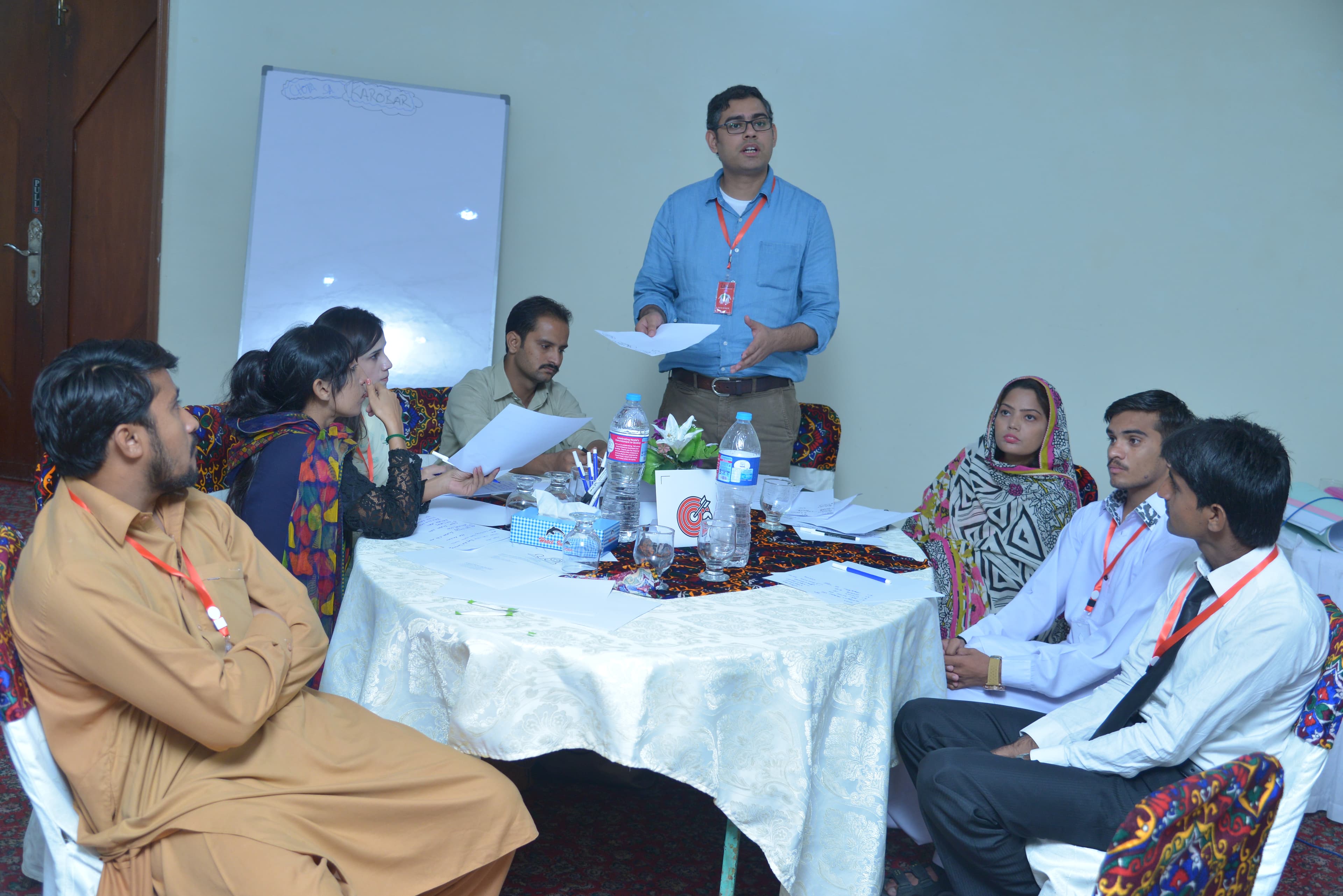 Workshop facilitator sketching a programme framework on a whiteboard