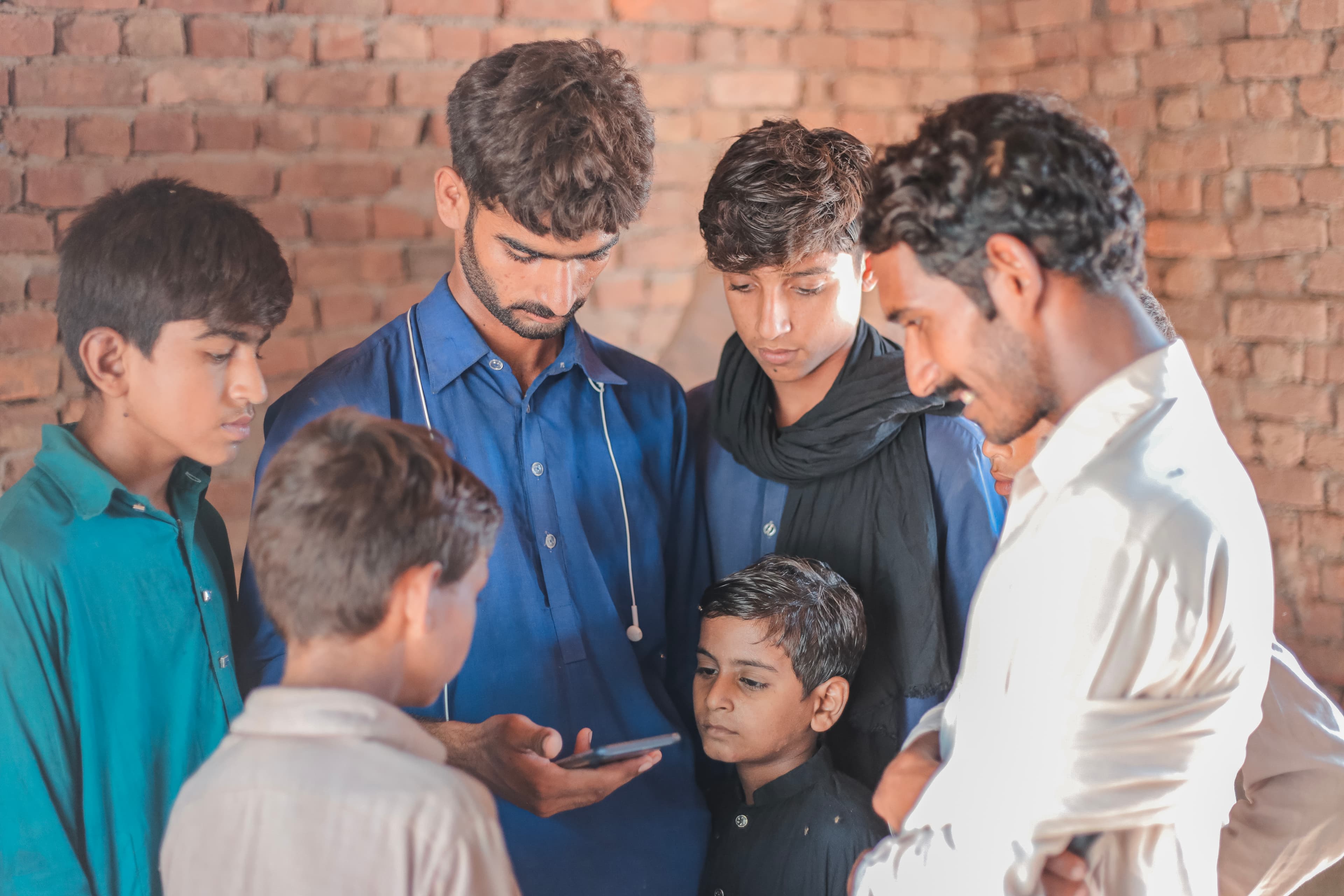Children gathered around a Clean & Green demonstration in a village school