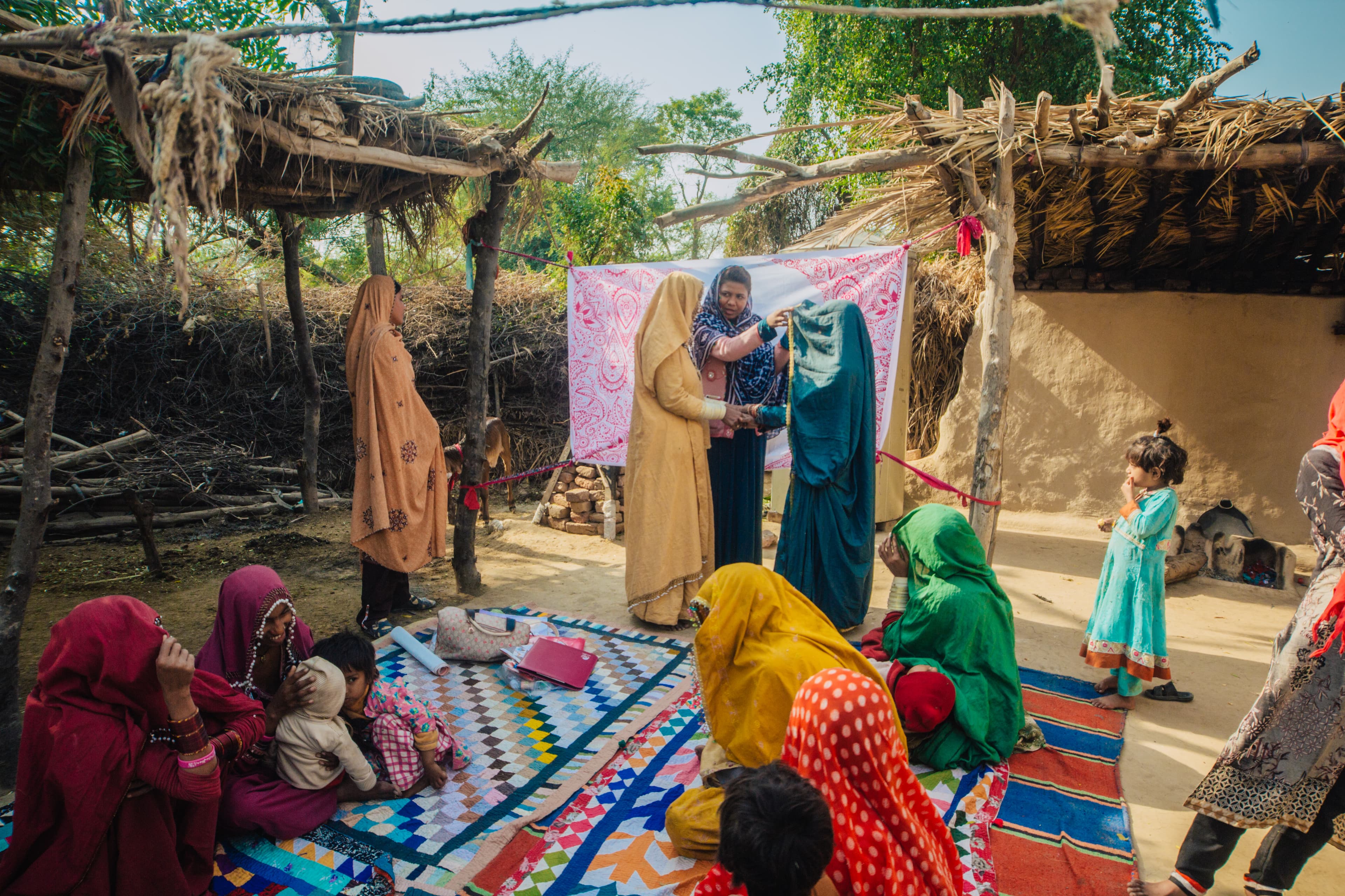 Frontline health workers reviewing session plans before a community visit