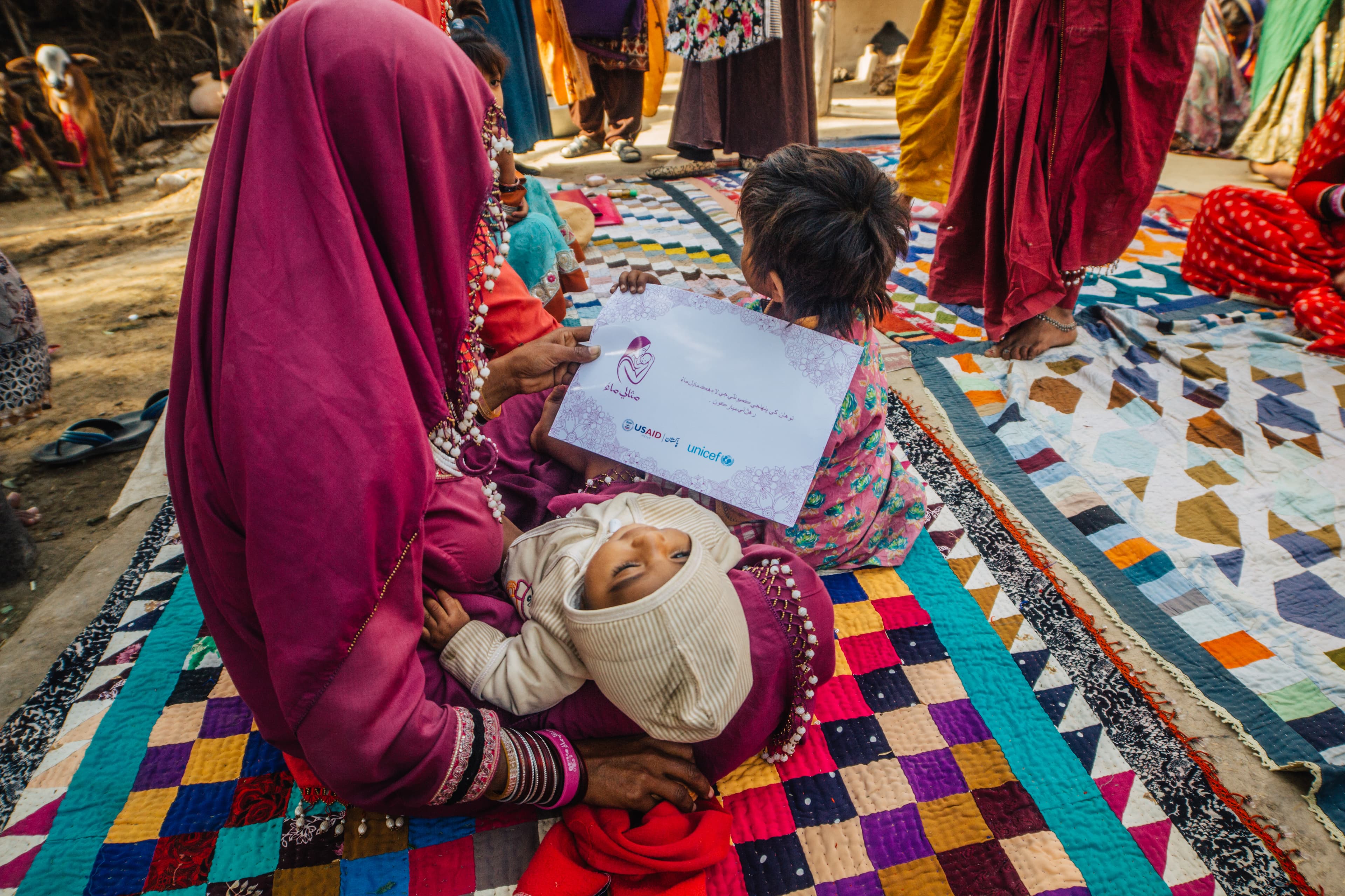 Children playing outside during a Misaali Maa community gathering in rural Sindh