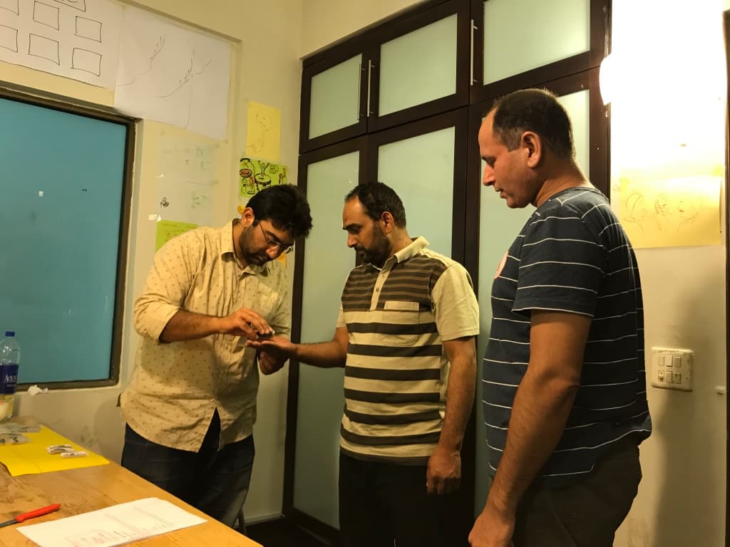 Mothers practising infant feeding techniques during a group demonstration